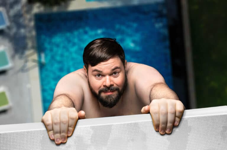Michael Bauer hängt auf einem 10-Meter-Turm unter ihm ein Pool